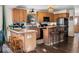 A spacious kitchen with wooden cabinets, stainless appliances, and an island with barstool seating offers an eat-in space at 609 Brook Dr, Idaho Springs, CO 80452