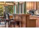 Stylish kitchen with custom wood bar seating, pendant lighting, and scenic views provides a perfect culinary setting at 609 Brook Dr, Idaho Springs, CO 80452