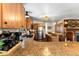 Open-concept kitchen featuring granite countertops, stainless steel appliances, and wood cabinetry offers a modern touch at 609 Brook Dr, Idaho Springs, CO 80452