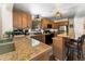 Modern kitchen with granite countertops, wood cabinets, and breakfast bar offers functionality and style at 609 Brook Dr, Idaho Springs, CO 80452