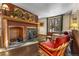 Inviting living room with wood-burning stove, stone fireplace, and comfortable seating creates a relaxing atmosphere at 609 Brook Dr, Idaho Springs, CO 80452