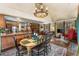 Cozy open concept living and dining area featuring a fireplace, kitchen bar and vaulted ceilings at 609 Brook Dr, Idaho Springs, CO 80452