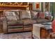 Comfortable living room with a large leather couch and rustic coffee table, creating a cozy and inviting space at 609 Brook Dr, Idaho Springs, CO 80452