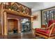 Warm and inviting living room featuring wood-burning stove, rustic fireplace, and comfortable seating at 609 Brook Dr, Idaho Springs, CO 80452
