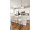 Contemporary kitchen featuring modern white cabinetry, stainless appliances, and a central island at 1208 Quitman St # 305, Denver, CO 80204