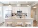 Bright kitchen with stainless steel appliances, white cabinets, and a center island with seating at 1208 Quitman St # 305, Denver, CO 80204
