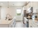 Modern kitchen features stainless steel appliances, bright countertops, and ample natural light at 1208 Quitman St # 305, Denver, CO 80204
