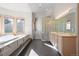 Luxurious bathroom with a soaking tub, glass-block shower and dual vanity at 23655 Currant Dr, Golden, CO 80401