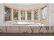 Bathroom features a luxurious tub surrounded by windows with beautiful view at 23655 Currant Dr, Golden, CO 80401