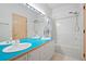 Bright bathroom with a double vanity and bathtub with showerhead at 23655 Currant Dr, Golden, CO 80401