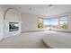 Bright bedroom featuring a fireplace with marble surround and beautiful mountain views from the large bay window at 23655 Currant Dr, Golden, CO 80401