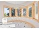 Bright dining area with many windows and tile flooring, offering ample natural light at 23655 Currant Dr, Golden, CO 80401