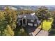 Two-story home surrounded by trees features a tiled roof and attached two-car garage at 23655 Currant Dr, Golden, CO 80401