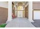 Charming entryway with double doors, sidelights, grand columns, and a cozy bench at 23655 Currant Dr, Golden, CO 80401