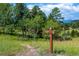 Community hiking trail with trail marker, surrounded by lush greenery and scenic natural beauty at 23655 Currant Dr, Golden, CO 80401