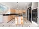 Spacious kitchen showcasing tile flooring, granite countertops, and an eat-in island at 23655 Currant Dr, Golden, CO 80401