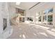 Large living room with marble fireplace, grand staircase, and open layout, bathed in natural light at 23655 Currant Dr, Golden, CO 80401