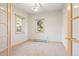 Carpeted home office featuring two large windows and natural wood trim at 23655 Currant Dr, Golden, CO 80401