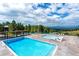 Community pool area featuring a main pool, pool, and scenic views with trees and mountains at 23655 Currant Dr, Golden, CO 80401