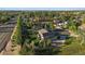 Aerial view of the home with solar panels situated on a tree-lined lot with a fenced backyard at 9375 Webster Way, Westminster, CO 80021