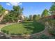 Expansive backyard featuring a well-manicured lawn, mature trees, and a stone-bordered flower bed at 9375 Webster Way, Westminster, CO 80021