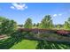 A well-maintained backyard with lush lawn, mature trees, and manicured landscaping at 9375 Webster Way, Westminster, CO 80021