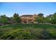 Wide backyard showing covered patio, mature trees, shrubbery, and lawn at 9375 Webster Way, Westminster, CO 80021