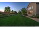 Large backyard with green grass, mature trees, lush landscaping, and privacy fencing at 9375 Webster Way, Westminster, CO 80021