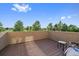 A spacious outdoor balcony with partial views of landscaping and a seating area at 9375 Webster Way, Westminster, CO 80021