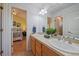 Well-lit bathroom featuring double sinks and a peek into an adjacent bedroom at 9375 Webster Way, Westminster, CO 80021