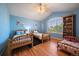 Shared bedroom with two twin beds and a smaller toddler bed with hardwood floors at 9375 Webster Way, Westminster, CO 80021