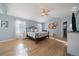 A spacious bedroom with light blue walls, hardwood flooring, and a ceiling fan at 9375 Webster Way, Westminster, CO 80021