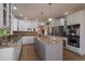 Lovely kitchen features stainless steel appliances, granite counters, tiled floors and plenty of cabinet space at 9375 Webster Way, Westminster, CO 80021