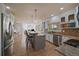Spacious kitchen featuring granite countertops, stainless steel appliances, and an island with bar seating at 9375 Webster Way, Westminster, CO 80021