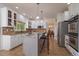 Bright kitchen with stainless steel appliances, granite counters and center island with barstool seating at 9375 Webster Way, Westminster, CO 80021