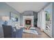 Living room with a fireplace, a cozy chair, and access to an outdoor balcony at 9375 Webster Way, Westminster, CO 80021