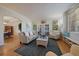 Bright living room featuring hardwood floors, neutral-colored furniture, and multiple windows for natural light at 9375 Webster Way, Westminster, CO 80021