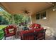 Covered patio offers comfortable seating area, ceiling fan, and outdoor waterfall feature at 9375 Webster Way, Westminster, CO 80021