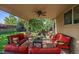 Covered patio offers comfortable seating area, ceiling fan, and view of beautiful backyard at 9375 Webster Way, Westminster, CO 80021