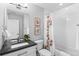 Bathroom with a framed mirror, tiled shower, and matching wall art at 3522 S Ogden St, Englewood, CO 80113