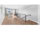 Hallway with black metal banister, wood floors, and a desk near a patio at 3522 S Ogden St, Englewood, CO 80113