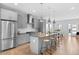 Open kitchen and dining area featuring a large island, stainless steel appliances, and modern lighting at 3522 S Ogden St, Englewood, CO 80113