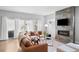 Stylish living room featuring a stone fireplace, hardwood floors, and plenty of natural light at 3522 S Ogden St, Englewood, CO 80113