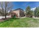 Expansive backyard with lush lawn, patio, and mature trees surrounding the property at 8707 Windhaven Dr, Parker, CO 80134