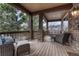 Relaxing covered balcony with comfortable seating and wood flooring at 8707 Windhaven Dr, Parker, CO 80134