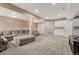 Large basement featuring a sectional sofa, an ottoman, built in cabinets and carpet flooring at 8707 Windhaven Dr, Parker, CO 80134
