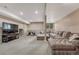 Spacious carpeted basement with comfortable seating, media center and foosball table for entertaining at 8707 Windhaven Dr, Parker, CO 80134
