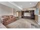 Finished basement with carpeted floors, a large entertainment center, and a comfortable sofa at 8707 Windhaven Dr, Parker, CO 80134