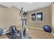 Finished basement with a window and an exercise machine and blue exercise ball at 8707 Windhaven Dr, Parker, CO 80134