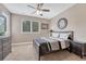 This bedroom has a ceiling fan and two large windows with plenty of natural light at 8707 Windhaven Dr, Parker, CO 80134